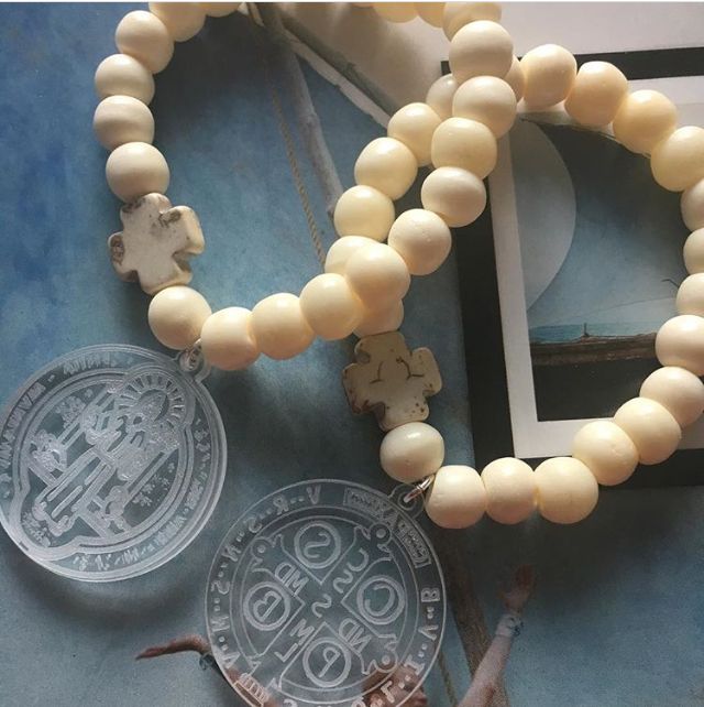 White bone bracelets and medal of Saint Benedict